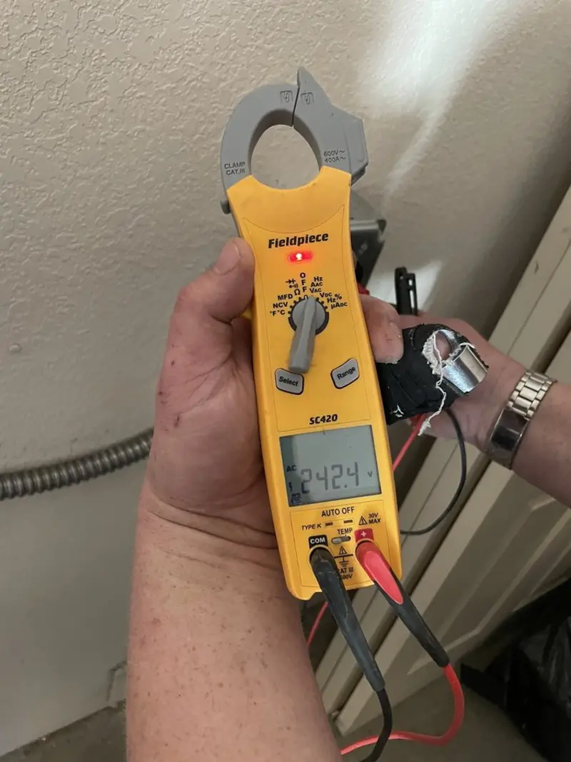 Voltage testing with clamp meter during Outlet Installation in Grandview Heights